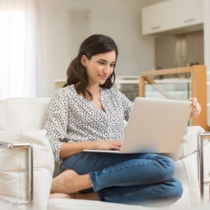 woman on laptop searching for an independent financial adviser to help with a stocks and shares isa