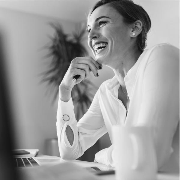 A woman laughing while sorting out their independent financial planning